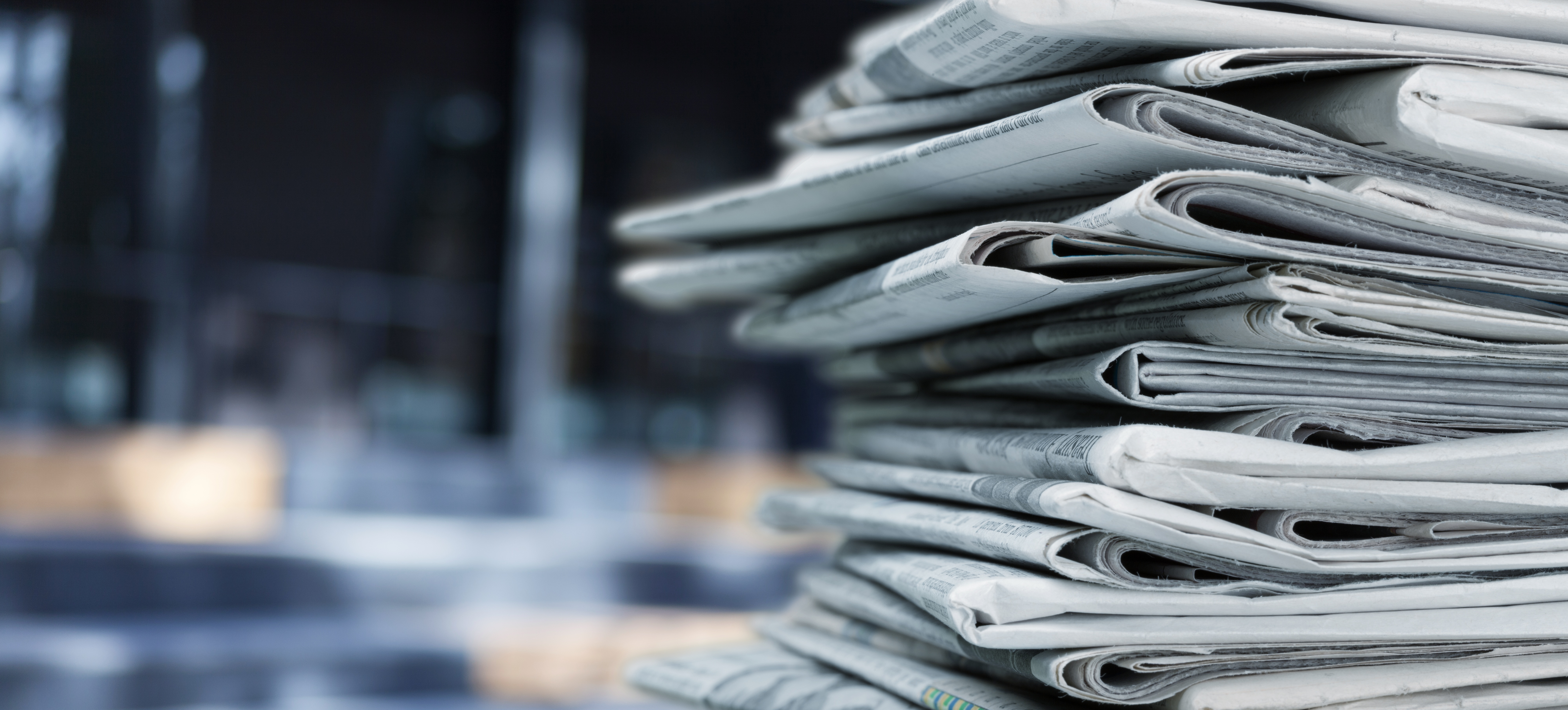 pile-fresh-newspapers-blur-background
